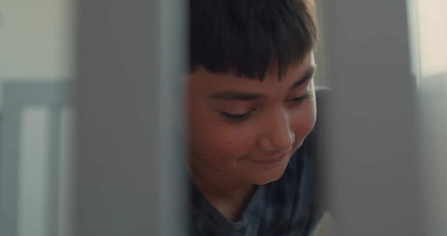 A child is building a crib and smiling