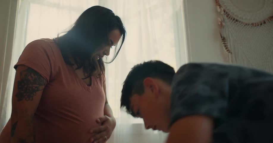 Boy helping a pregnant mother