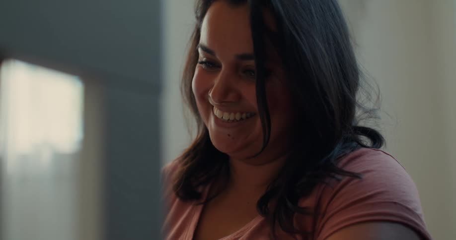 Portrait of a woman in an indoor space talking happily