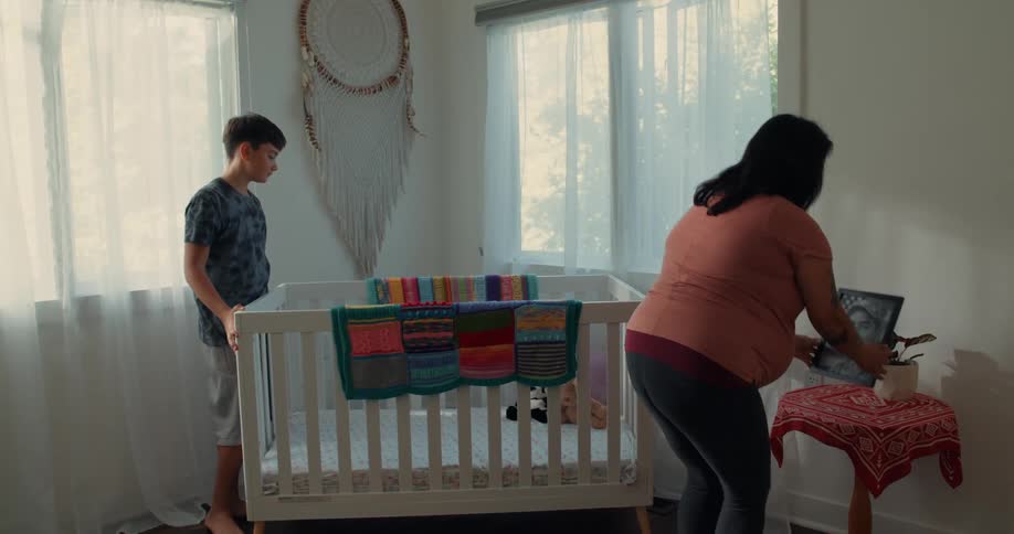 A clip of a woman placing a frame on a stool