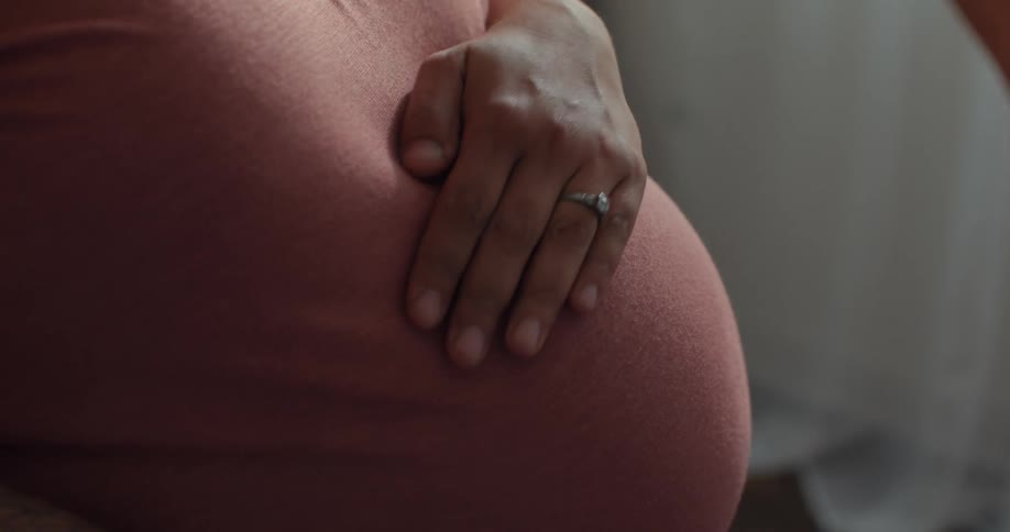 A footage of a pregnant woman rubbing her tommy