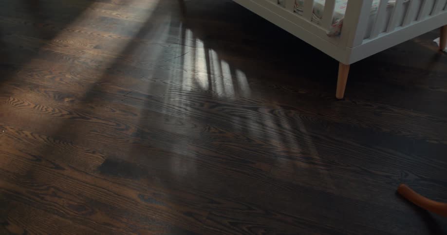 Crib in a room on a laminate floor