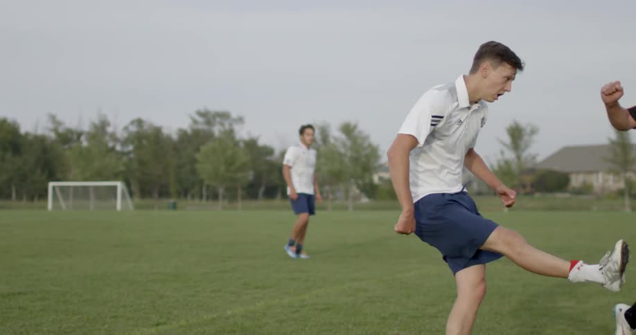 Men play soccer on an outdoor field