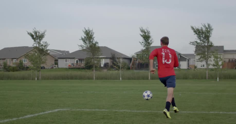 A player runs for the ball and kicks it