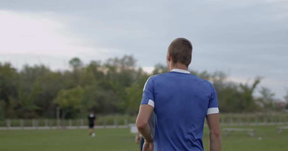 Players walk down the grass field