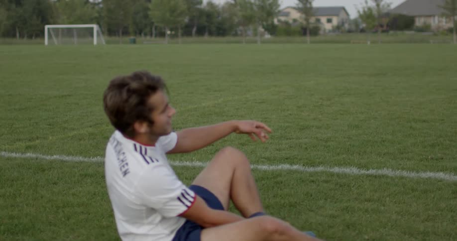 A man is sitting on the grass resting