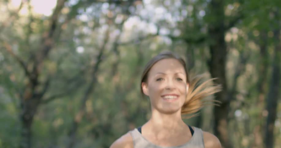 A woman jogs on a forest trail