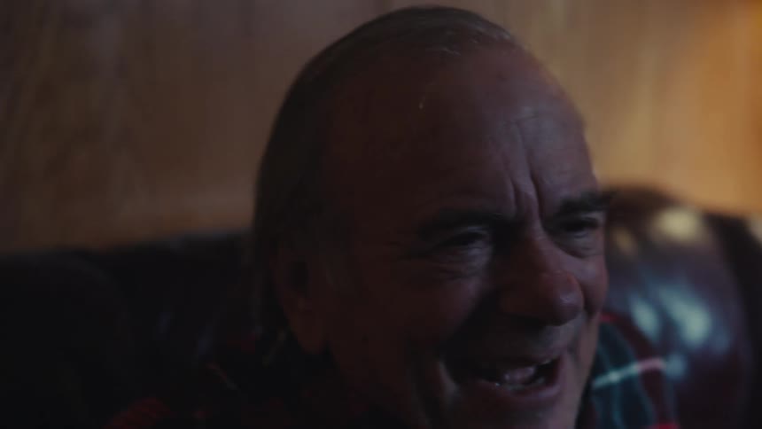 A close up clip of an elderly man excited