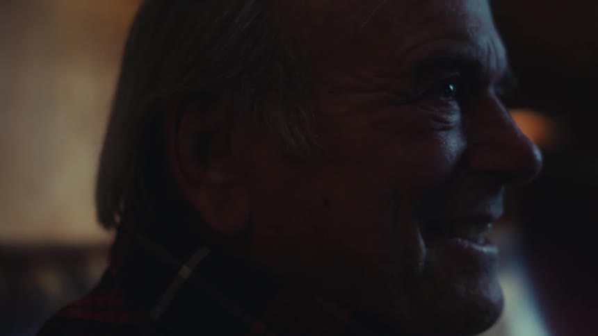 Side portrait of a happy cheering elderly man