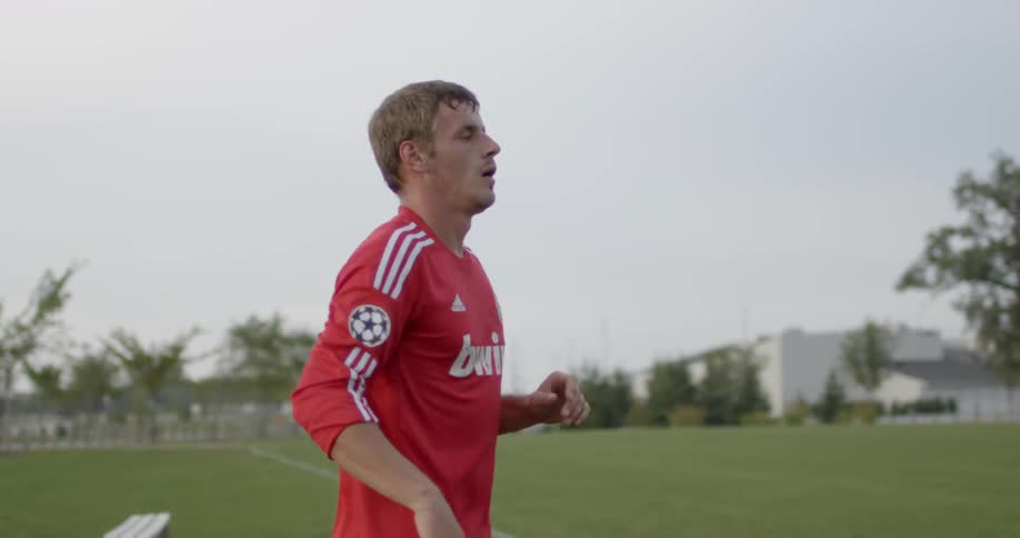 A soccer player jogs on the field