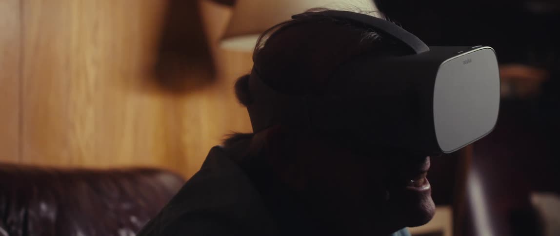 Close up of an elderly man wearing a virtual reality headset at home