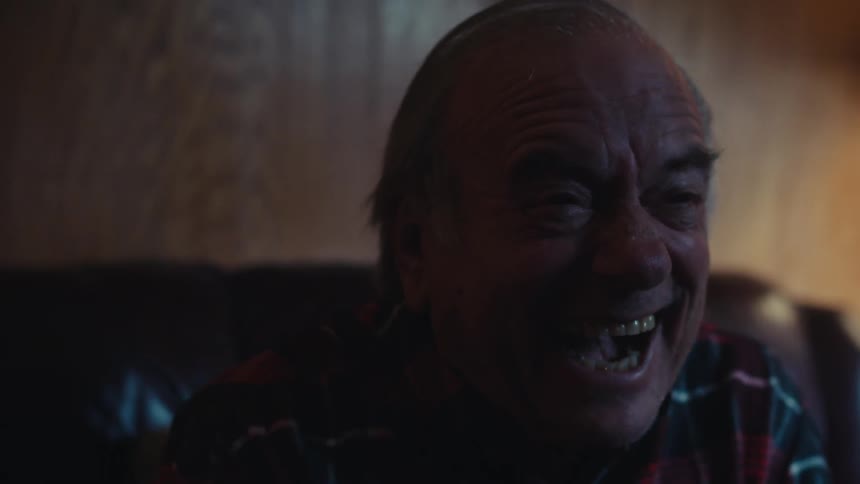 A man cheers and shouts while watching television