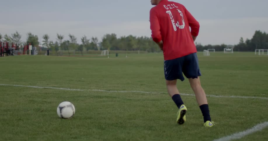 A soccer play passes the ball