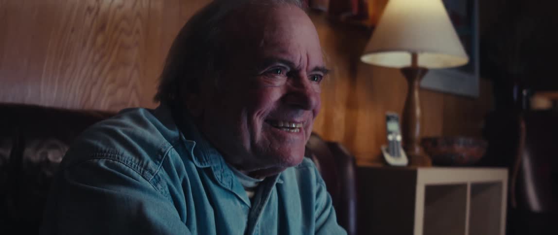 A footage of an elderly man playing a video game
