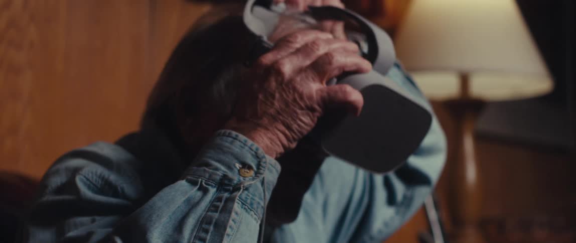 Elderly man putting on a vr headset