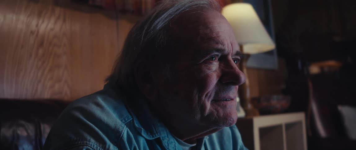 Portrait of a concentrated elderly man looking forward and smiling