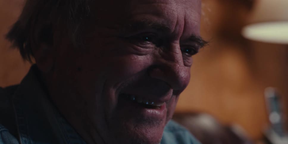 Portrait of an emotional elderly man putting on his glasses