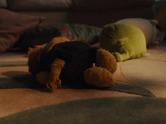 Hands of a child playing with teddy bears on a bedroom carpet