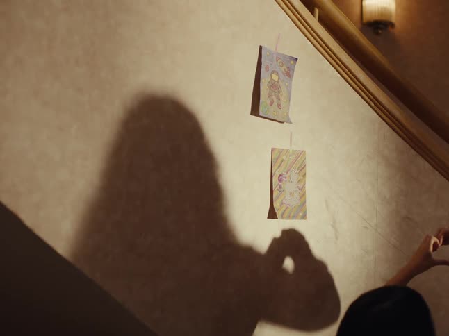 Drawings are hung then removed from the wall