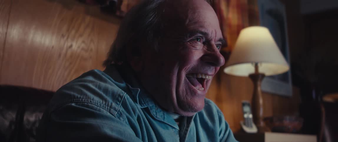 A man laughs while having fun playing video games