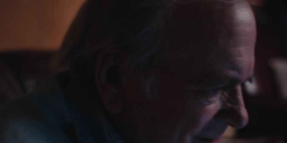 A footage of an elderly citizen holding a pen