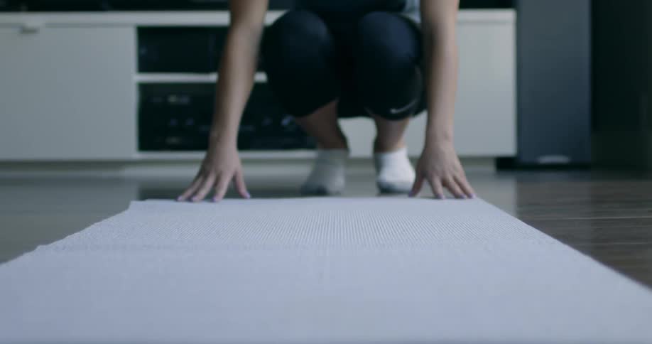 Someone is rolling out their yoga mat
