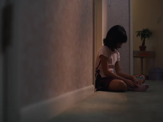 A child is playing with a toy before she knocks on the door