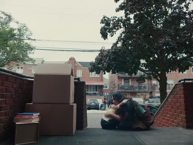 Woman hugging a child outside the house