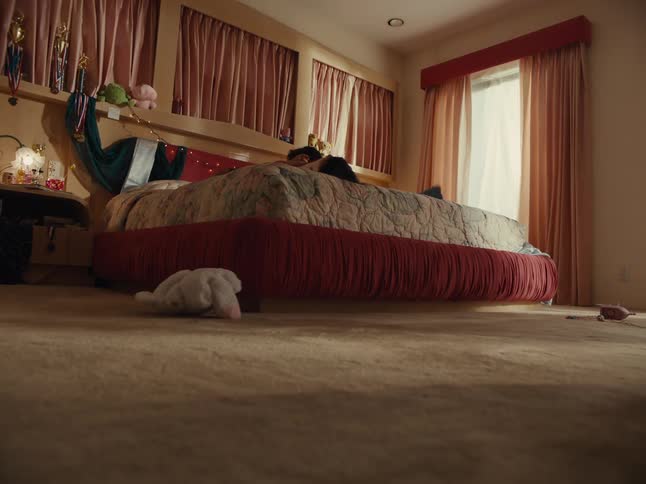 A mother and daughter are playing with plush toys in the bedroom