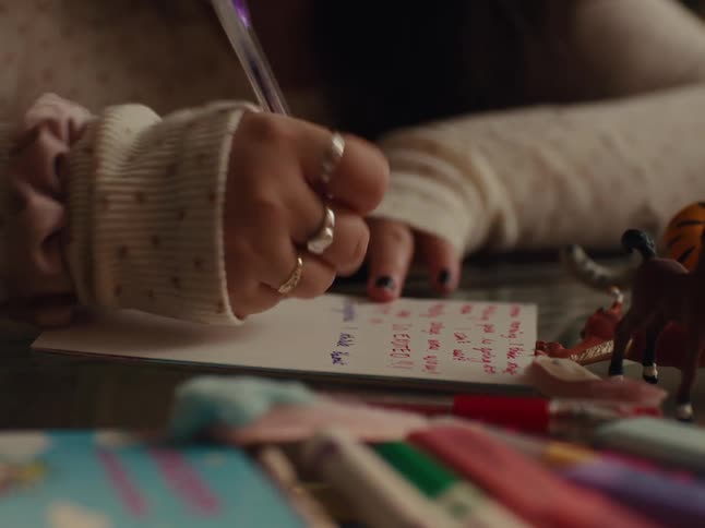 Hands of a person holding a pen and writing