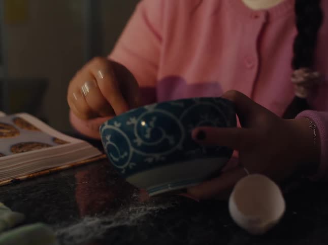 Hands of a person cooking in a bowl