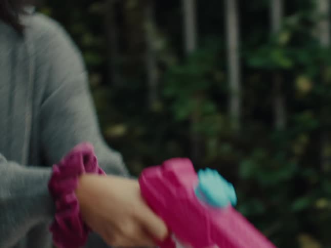 Two girls have a water gun fight