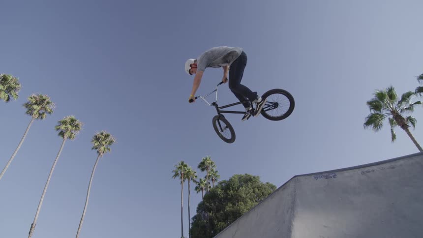 A bicyclist jumps on a ramp