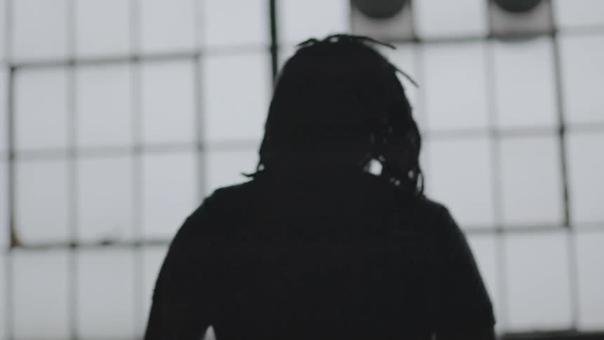 A man walking into a room filled with many windows