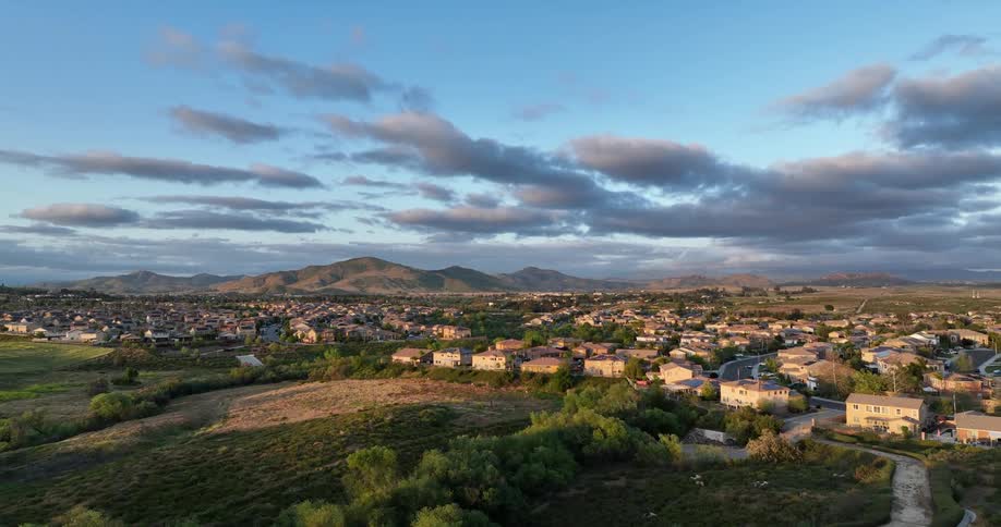 Past the hills is a suburb with many homes