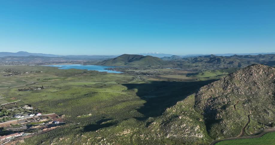 Aerial of a rural community in a mountain valley on a sunny summer day