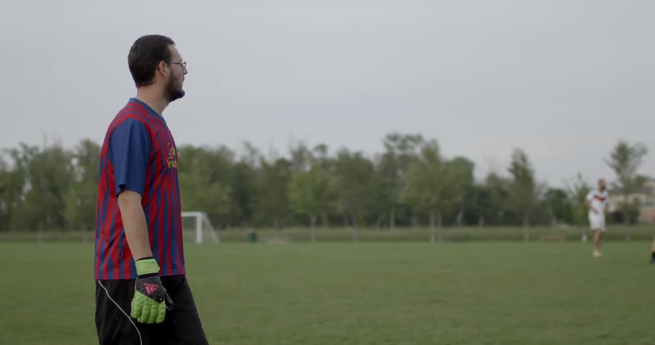 Soccer players standing around on a field