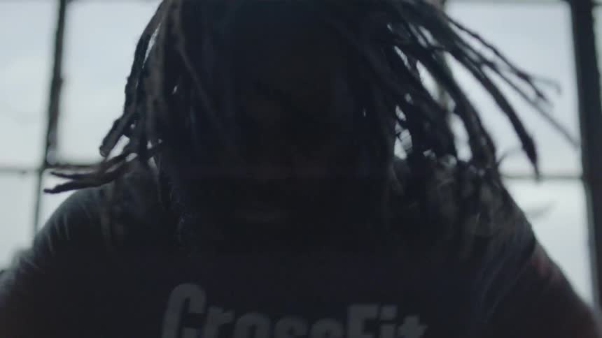 A man is working out on a bike in a gym
