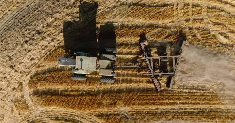 Aerial view of an agricultural machine working through a field