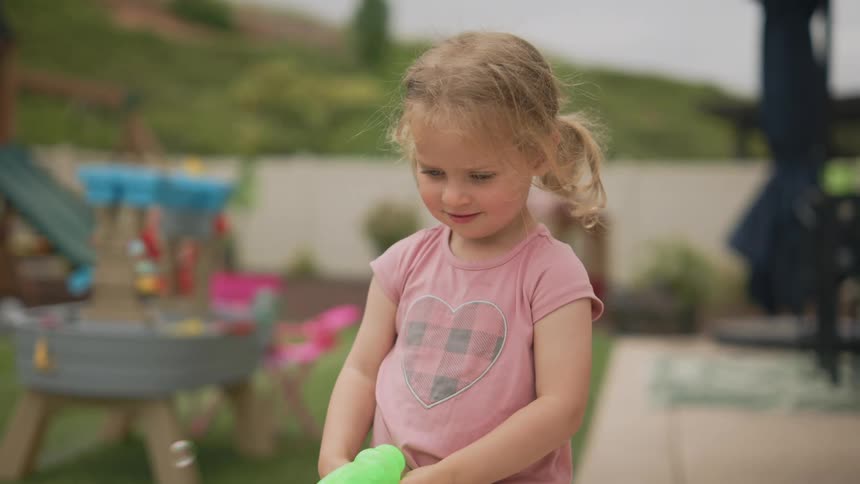 A footage of a little girl playing with a toy gun
