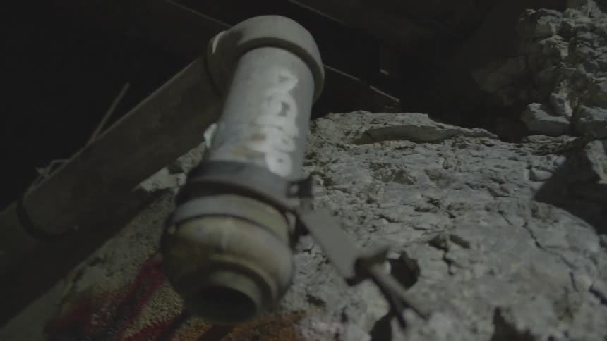 Close up of a pipe and a rock