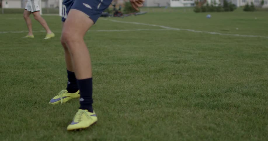 A soccer player kicks the ball