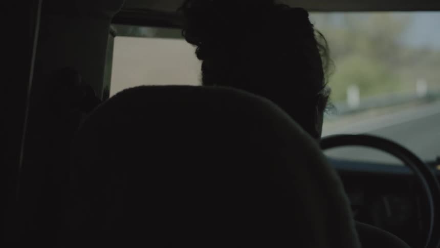 A person sitting in the front seat driving