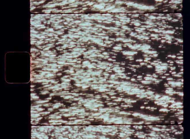 Close up of the sun reflection on the surface of a body of water caught on vintage film