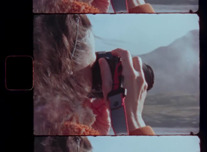 Woman in a natural environment using a professional camera