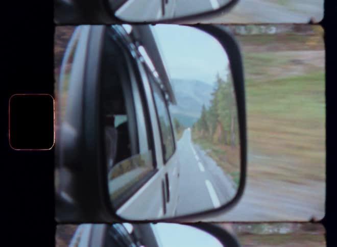 The reflection in a cars side mirror