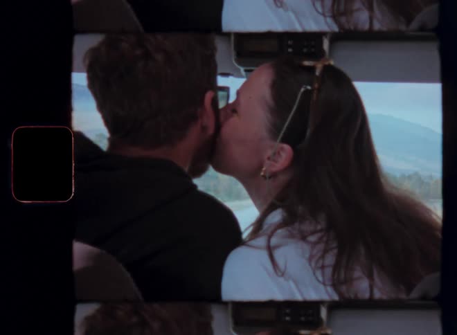 Couple traveling in a vehicle and kissing each other