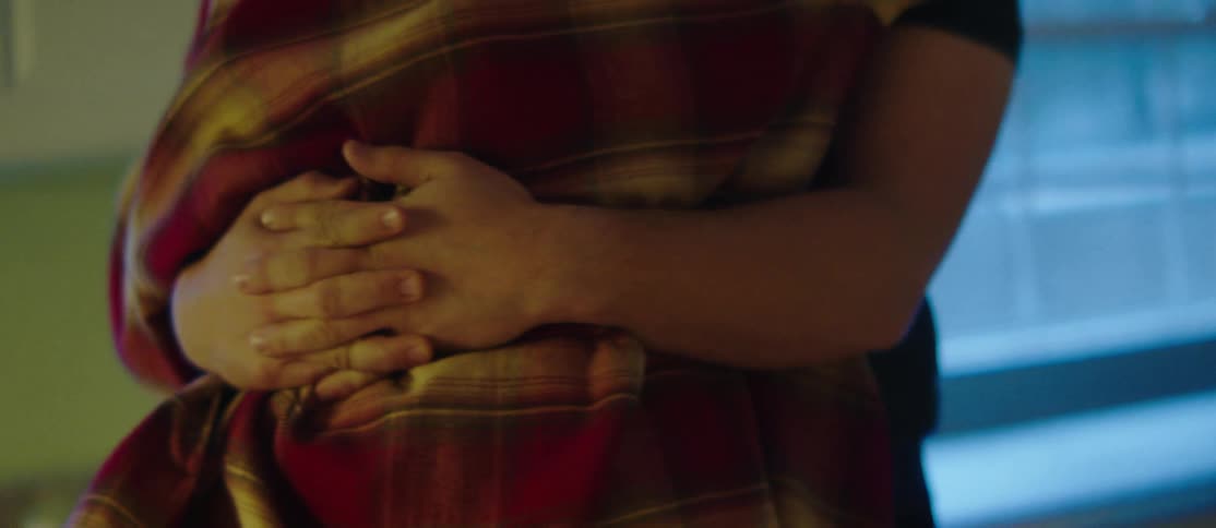 Closeup of the arms of a person hugging another