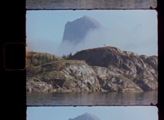 Landscape of rocks and mountains surrounded by water
