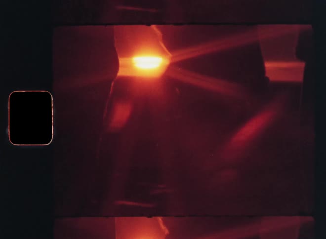 Closeup of two people holding hands against a reddish sky